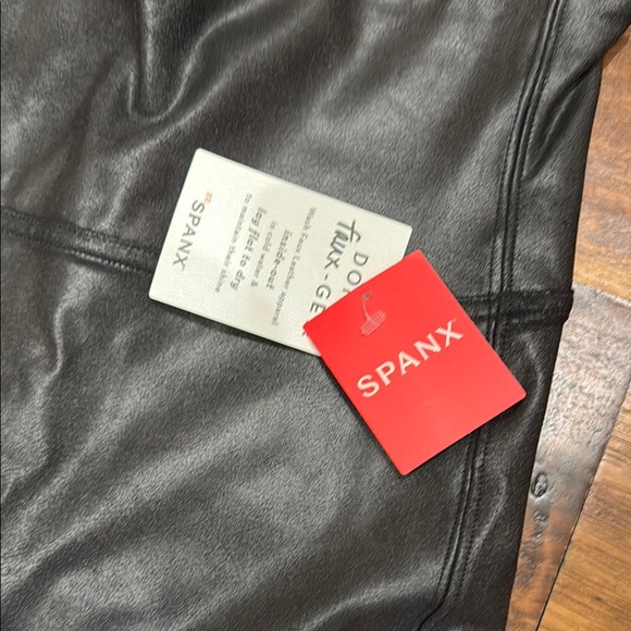 SPANX Black Faux Leather Leggings with a sleek form-fitting design - Picture 2 of 5